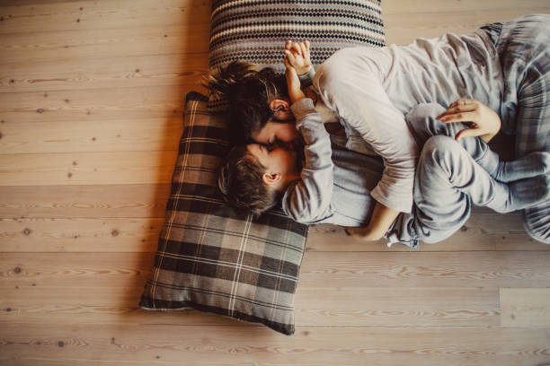 Mom with kid laying on floor | Leaf Floor Covering